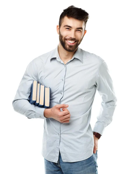 Jong gebaard lachende man met boeken in hand op wit — Stockfoto