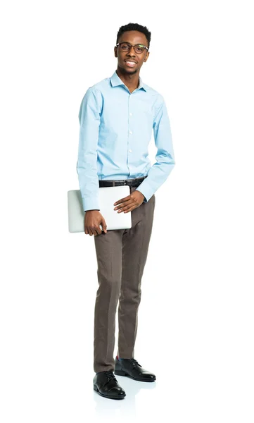 Happy african american college student standing with laptop on w — Stock Photo, Image