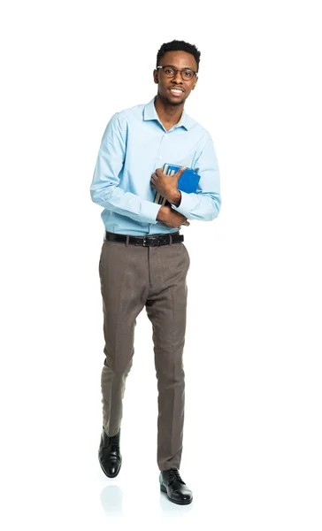 Happy african american college student standing with books in hi — Stock Photo, Image