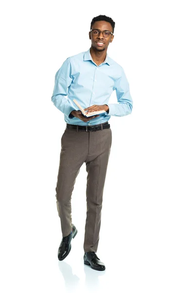 Happy african american college student standing with book on whi — Stock Photo, Image