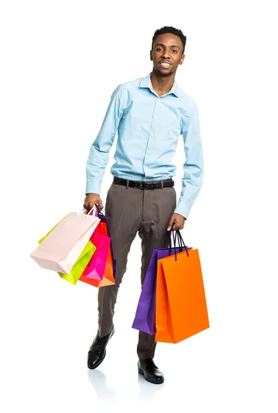 Gelukkig Afro-Amerikaanse man houden boodschappentassen op witte backgr — Stockfoto