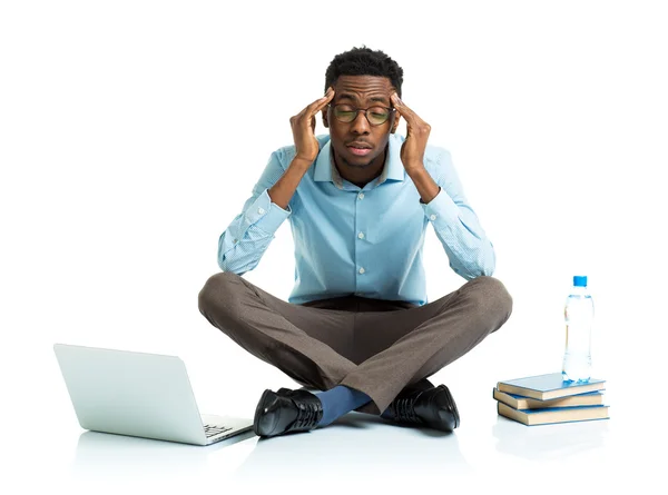 Happy african american college student in stress sitting with la — Stock Photo, Image