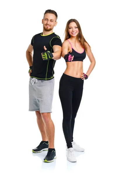 Lekkoatletycznego mężczyzna i kobieta po ćwiczeń fitness z palcem o — Zdjęcie stockowe