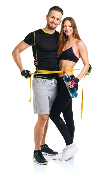 Счастливая спортивная пара - мужчина и женщина с измерительной лентой на — стоковое фото