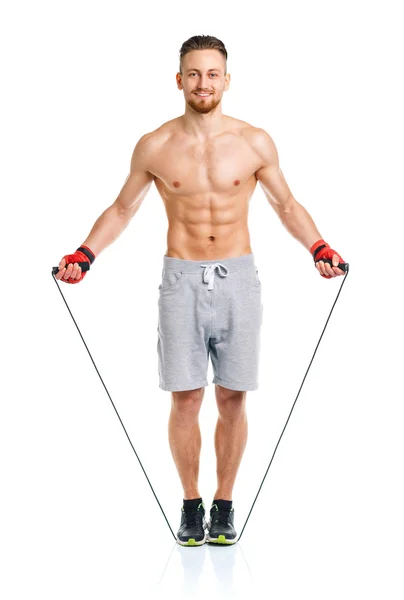 Athletic attractive man jumping on a rope on the white — Stock Photo, Image