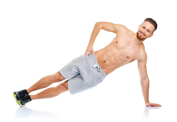 Athletic attractive man doing fitness exercises on the white — Stock Photo, Image