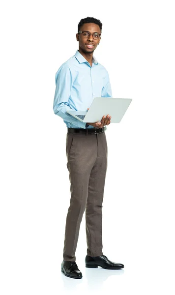 Happy african american college student standing with laptop on w — Stock Photo, Image