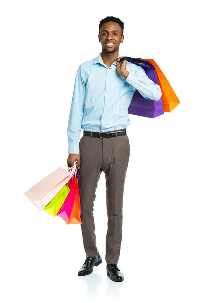 Happy african american man holding shopping bags on white backgr — Stock Photo, Image