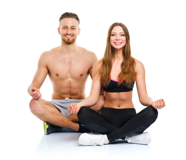 Sport couple - man and woman after fitness exercise sitting with — Stock Photo, Image