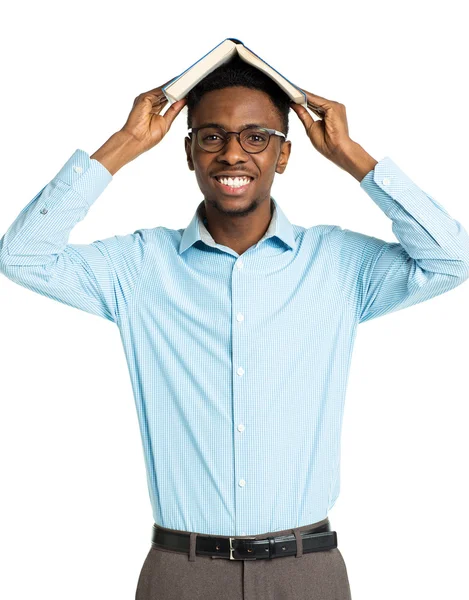 Happy african american college student standing with book on his Stock Photo