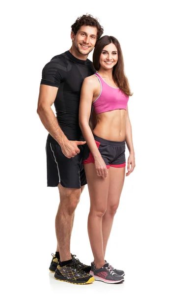 Casal atlético após o exercício de fitness no branco — Fotografia de Stock