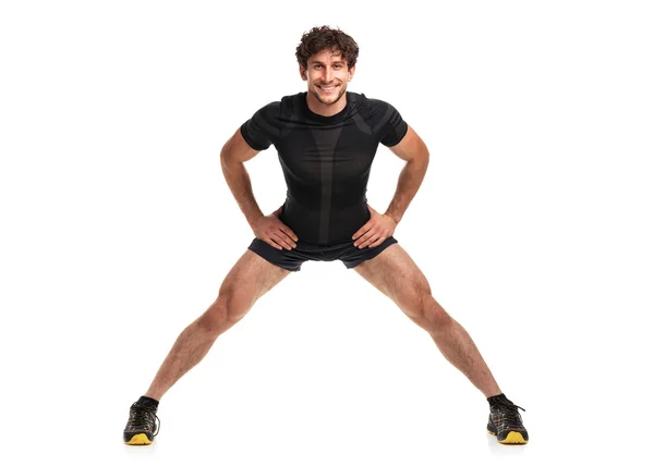 Athletic attractive man doing  fitness exersise on the white — Stock Photo, Image