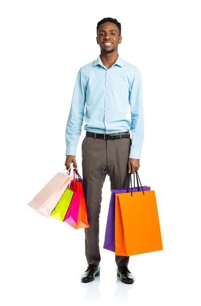 Glücklich afrikanisch-amerikanischer Mann mit Einkaufstaschen auf weißem Backgr — Stockfoto