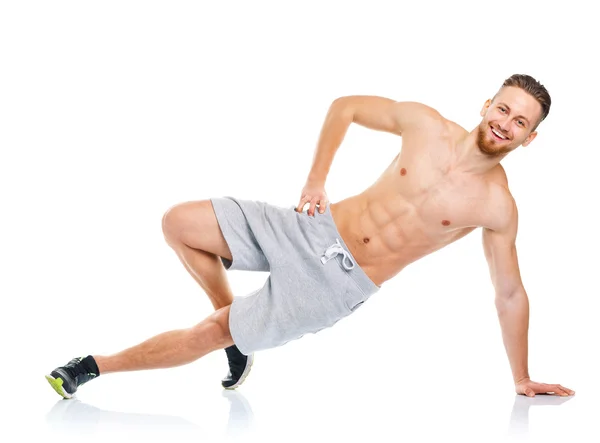 Sportovní atraktivní muž dělá fitness cvičení na bílé — Stock fotografie