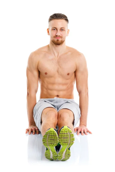 Sport attractive man doing fitness exercises on the white — Stock Photo, Image