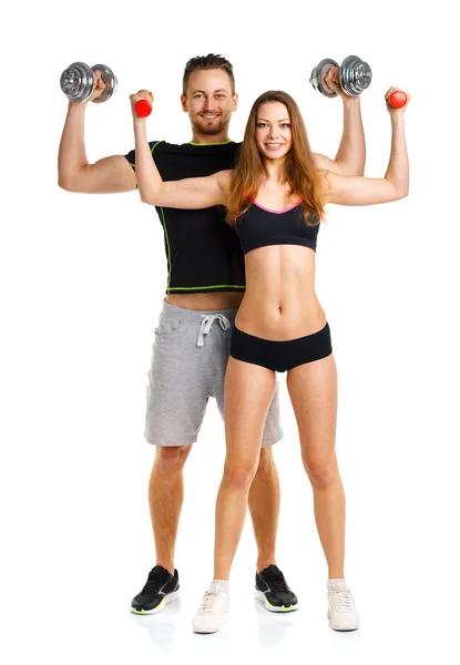 Couple sportif - homme et femme avec haltères sur le blanc — Photo