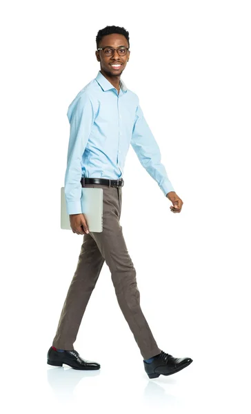 Happy african american college student with laptop standing on w — Stock Photo, Image