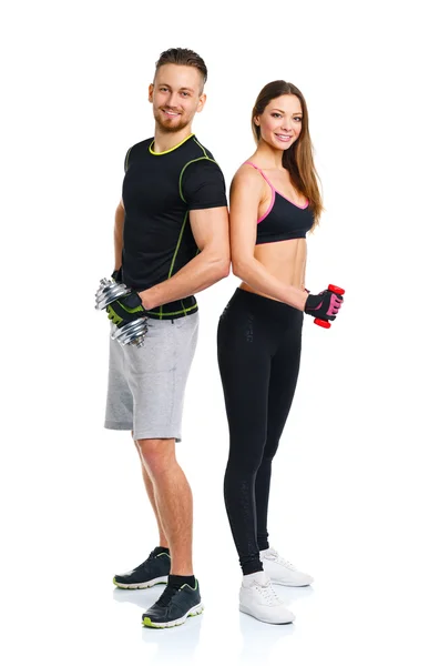 Sport couple - man and woman with dumbbells on the white — Stock Photo, Image