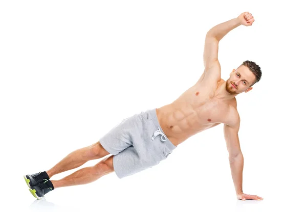 Atletische aantrekkelijke man doen fitness oefeningen op de witte — Stockfoto