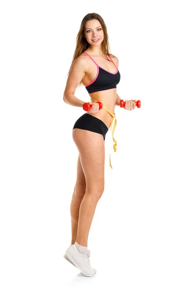 Krásná sportovní žena s činkami a měřicí pásky na wa — Stock fotografie