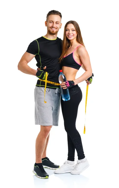 Happy athletic couple - man and woman with measuring tape on the — Stock Photo, Image