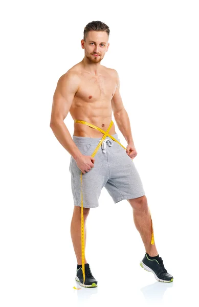 Athletic man with measuring tape on the white — Stock Photo, Image