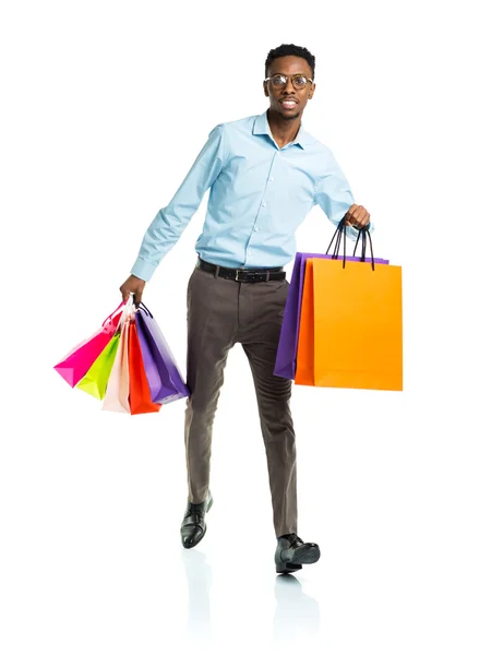 Happy african american man holding shopping bags on white. Holid — Stock Photo, Image