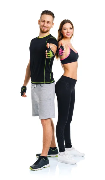 Athletic man and woman after fitness exercise with thumbs up on — Stock Photo, Image