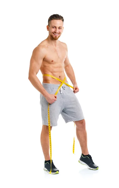 Athletic man with measuring tape on the white — Stock Photo, Image