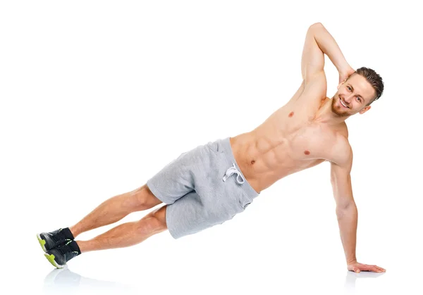 Sport attractive man doing fitness exercises on the white — Stock Photo, Image