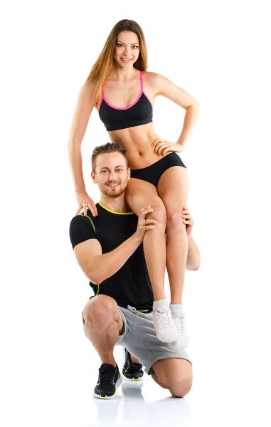 Athletic guy holds on shoulder a girl on a white — Stock Photo, Image