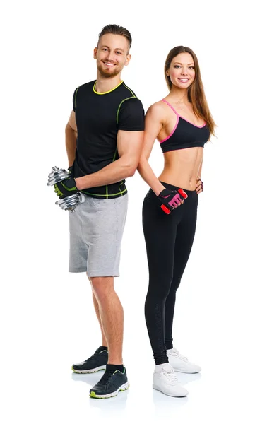 Pareja deportiva - hombre y mujer con mancuernas en el blanco — Foto de Stock