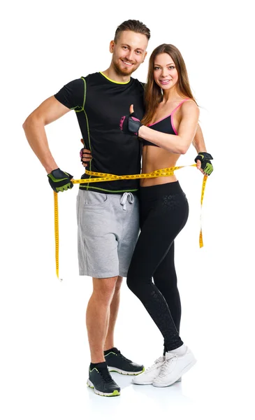 Happy athletic couple - man and woman with measuring tape on the — Stock Photo, Image