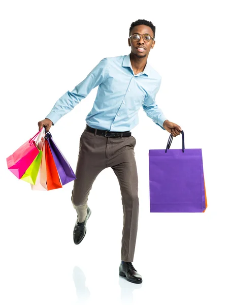 Happy african american man holding shopping bags on white. Holid — Stock Photo, Image