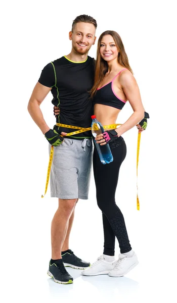 Happy sport couple - man and woman with measuring tape on the wh — Stock Photo, Image