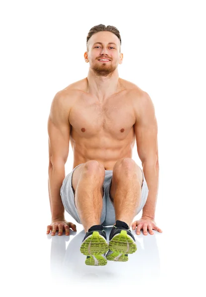 Deporte atractivo hombre haciendo ejercicios de fitness en el blanco — Foto de Stock