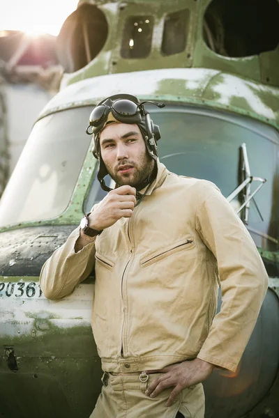 Young pilot posing near the helicopter — Stock Photo, Image