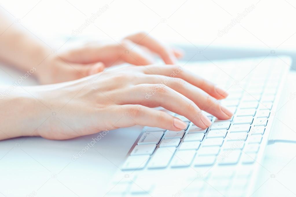 Female woman office worker typing on the keyboard