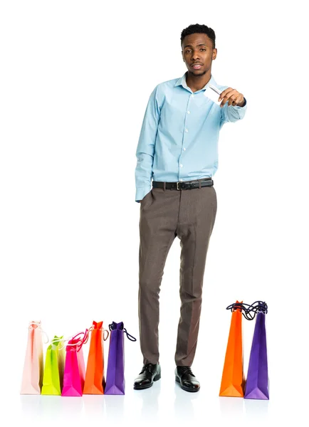 African american man with shopping bags and holding credit card — Stock Photo, Image