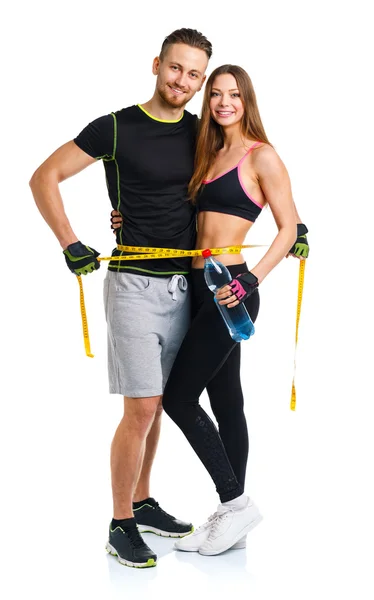 Happy sport couple - man and woman with measuring tape on the wh — Stock Photo, Image