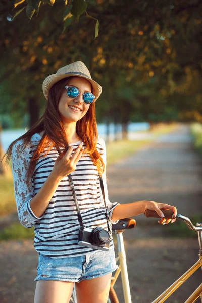 야외에서 자전거를 타고 모자 사랑 스러운 젊은 여자. 활성 pe — 스톡 사진