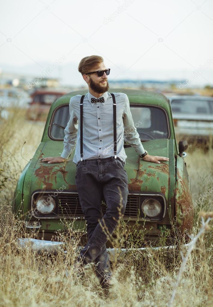 Portrait of a young handsome stylish man, wearing shirt and bow-