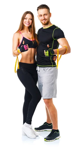 Lekkoatletycznego mężczyzna i kobieta po fitness ćwiczenia z kciukiem się na — Zdjęcie stockowe