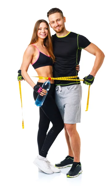 Happy sport par - man och kvinna med måttband på wh — Stockfoto