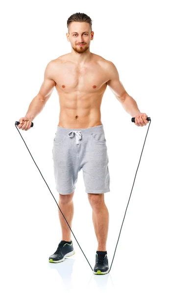 Athletic attractive man jumping on a rope on the white — Stock Photo, Image