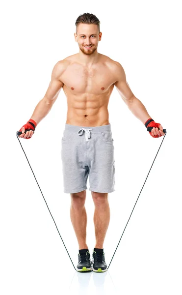 Athletic attractive man jumping on a rope on the white — Stock Photo, Image