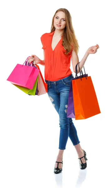 Happy lovely woman with shopping bags over white — Stock Photo, Image