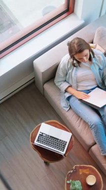 Kadının notlar yazıp konferans dinlemesi, evdeki kanepede uzanması. Yanında oturan tüylü kediler.