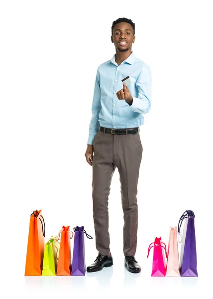 Happy african american man with shopping bags and holding credit
