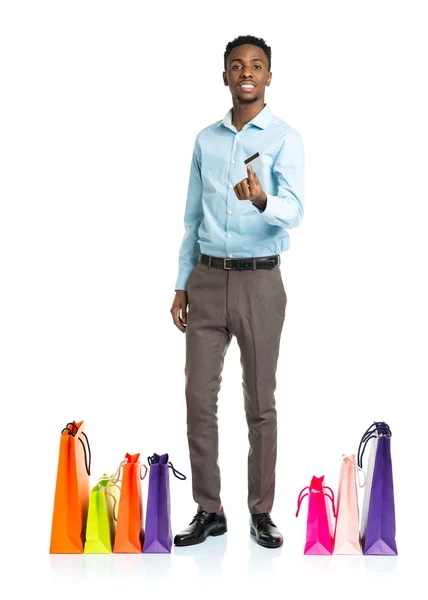 Happy african american man with shopping bags and holding credit — Stock Photo, Image